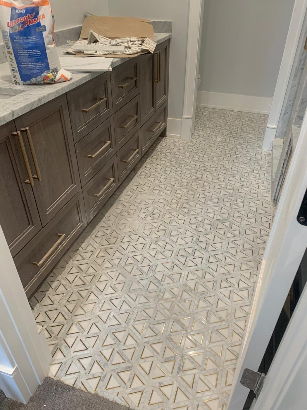 The same bathroom after the cleanout, with the marble floor cleared and cleaned