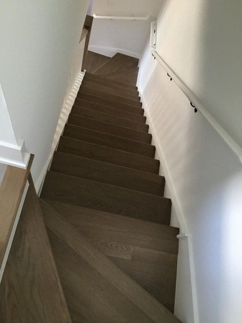 Clean staircase with wood treads and white walls