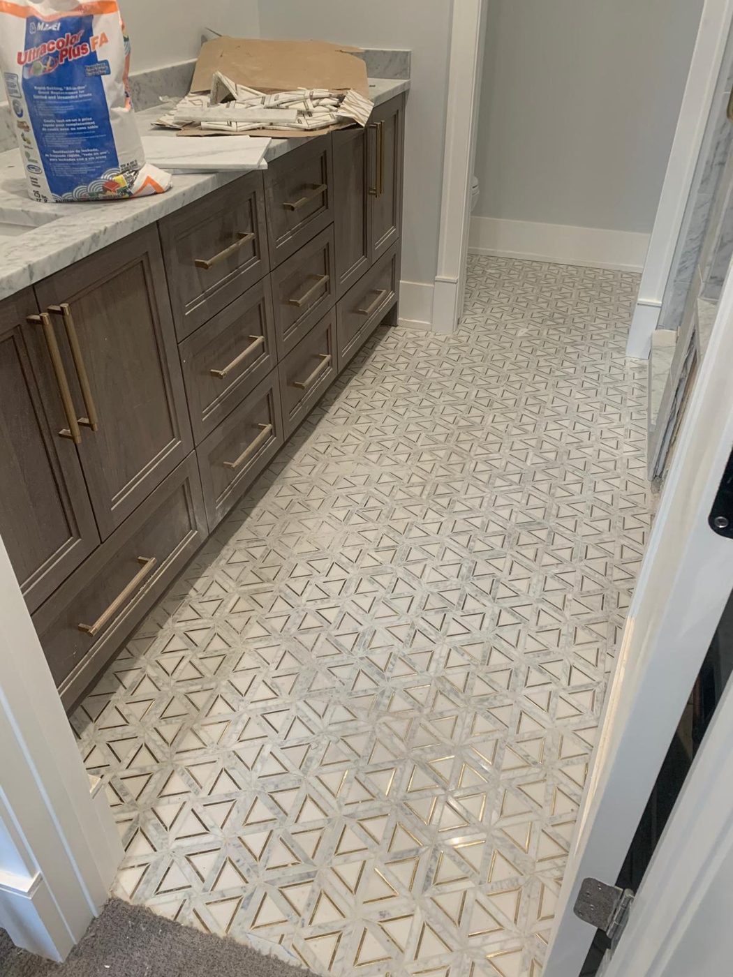 Same bathroom after heavy-duty cleanout — marble floor fully cleared and cleaned