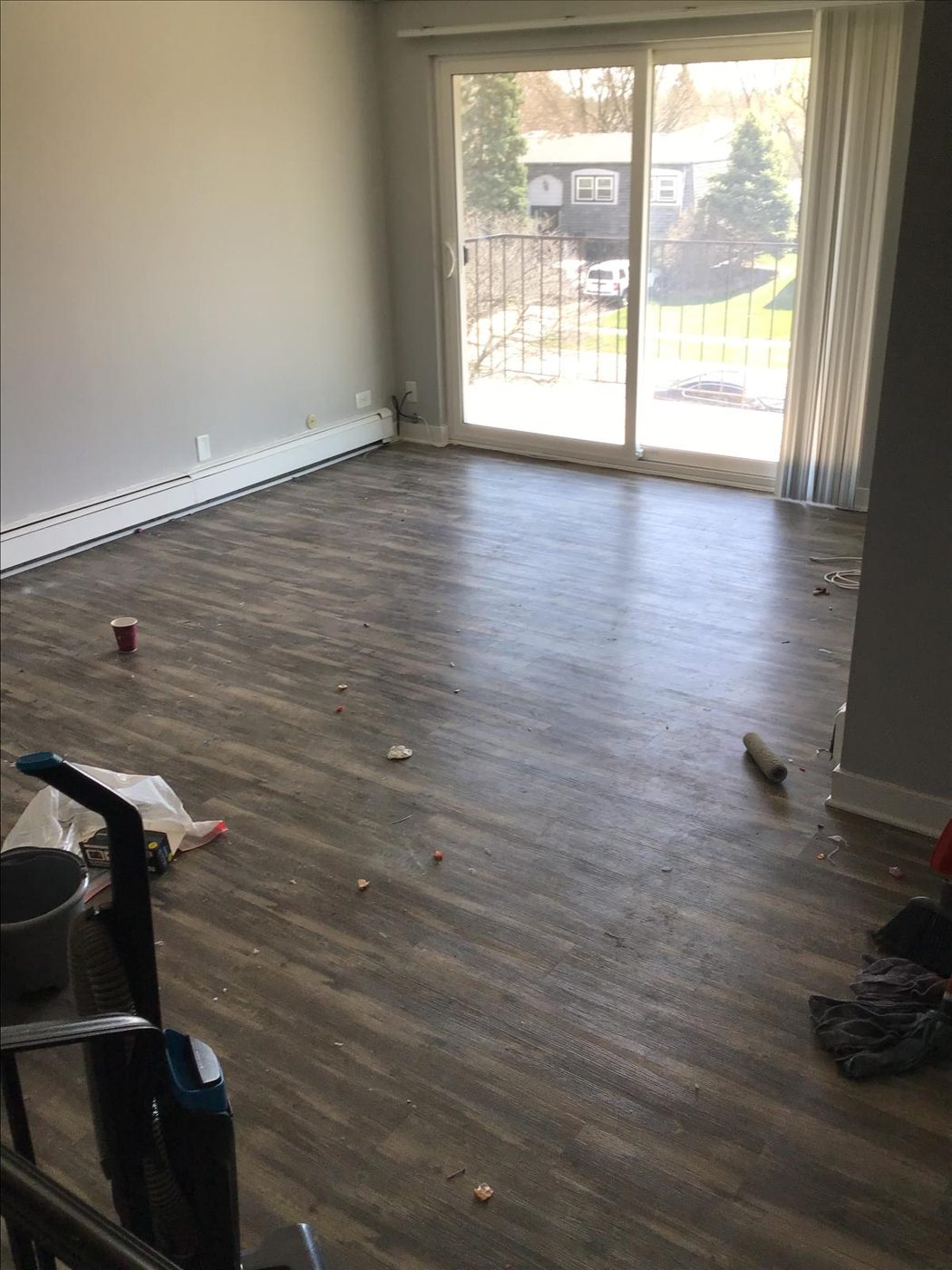 Townhome living room before cleaning — debris on floors