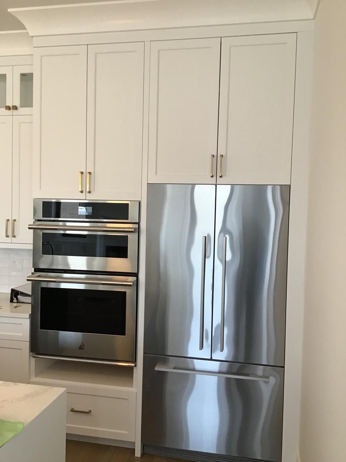 Spotless post-construction kitchen cleaned by Ale Cleaning — gleaming appliances and bright white cabinetry